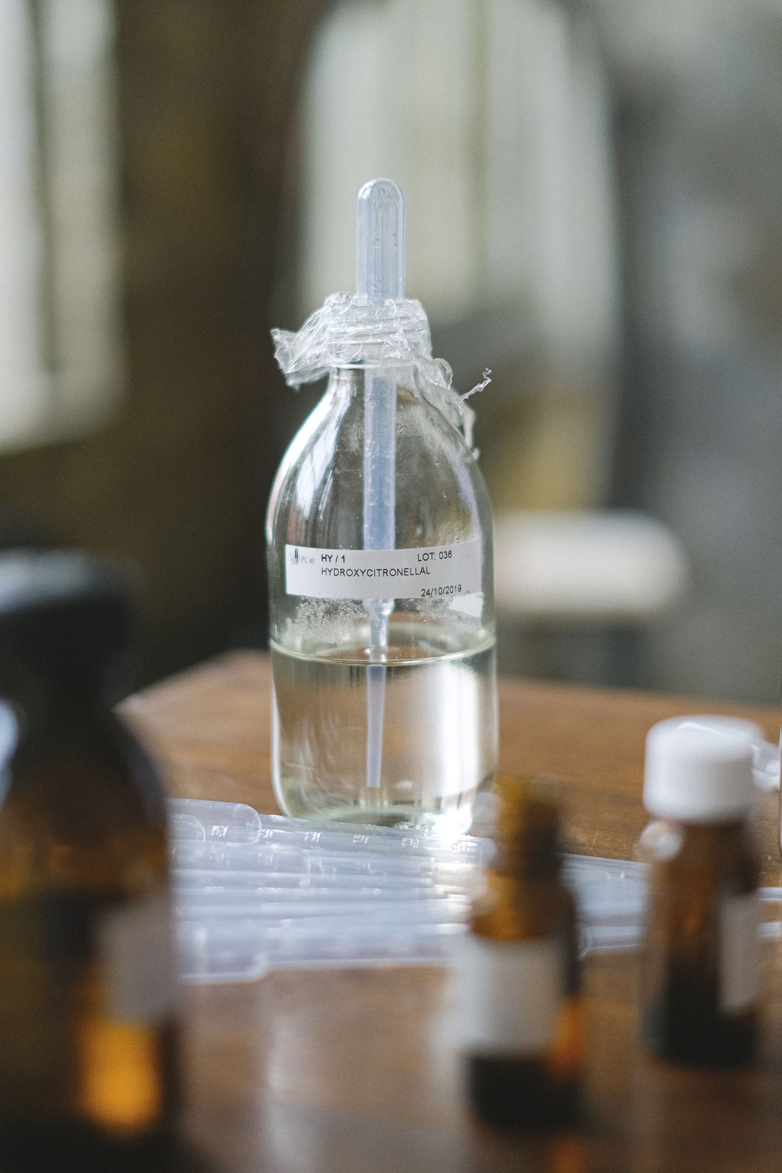 Close-up of a laboratory bottle label with Latin-script identification, lot number and date.